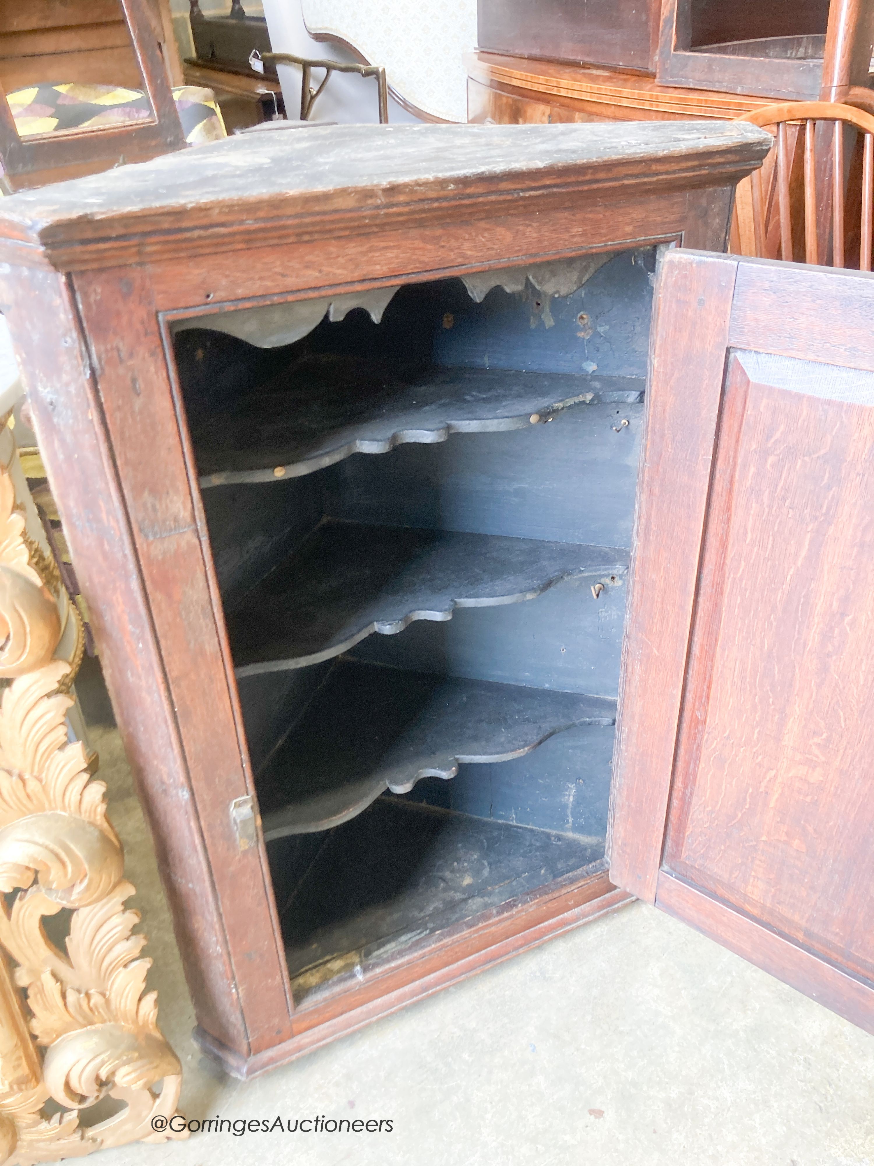 An 18th century oak hanging corner cupboard, width 70cm, depth 41cm, height 99cm